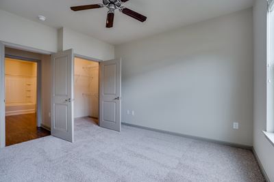 Bedroom with Ceiling Fan and Double Door Closet